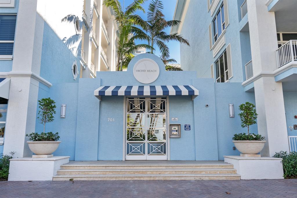 701 Southeast 21st Avenue, Unit 103 Deerfield Beach, FL 33441 - Photo 2 of 31 a view of a building with a potted plant ana a small yard