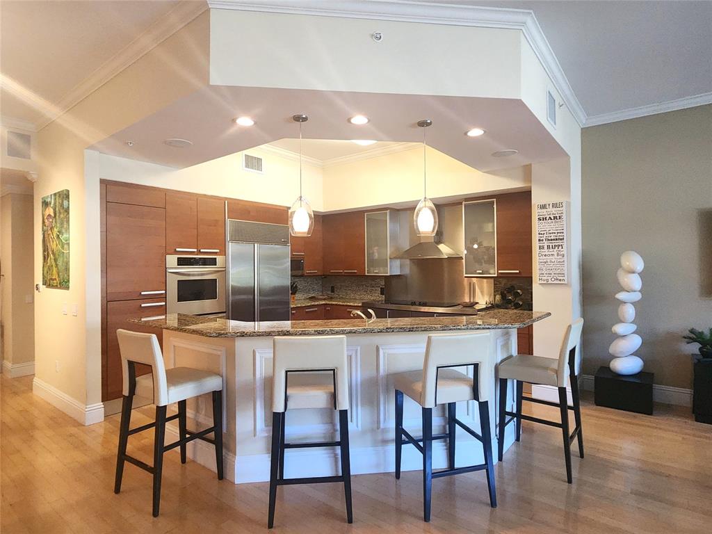 701 Southeast 21st Avenue, Unit 103 Deerfield Beach, FL 33441 - Photo 4 of 31 a kitchen with a table and chairs