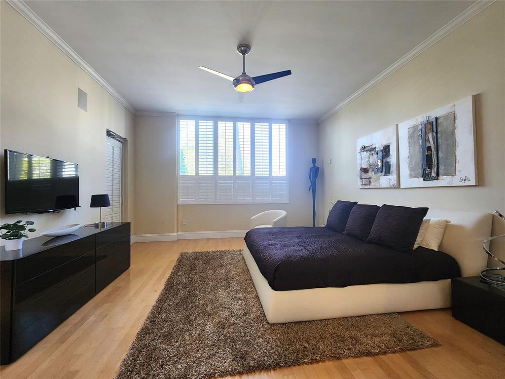 701 Southeast 21st Avenue, Unit 103 Deerfield Beach, FL 33441 - Photo 7 of 31 a living room with a couch and a flat screen tv