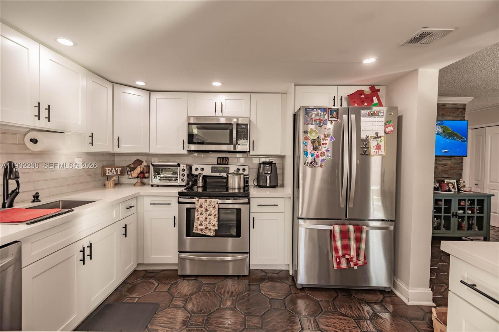 9404 Southwest 8th Terrace Miami, FL 33174 - Photo 20 of 41 a kitchen with stainless steel appliances granite countertop a refrigerator sink and microwave
