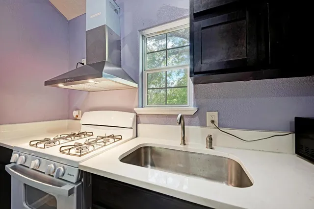 a kitchen with a stove and a sink