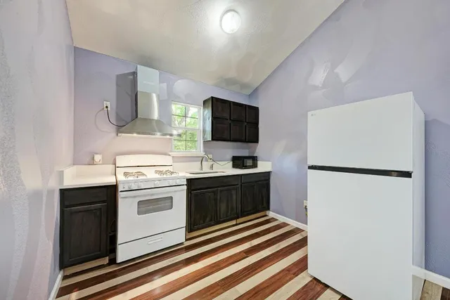 a kitchen with stainless steel appliances a refrigerator stove and sink