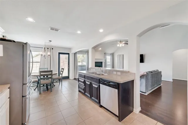 a kitchen with stainless steel appliances granite countertop a stove and a refrigerator