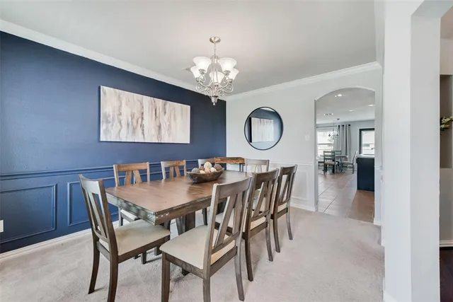 a view of a dining room with furniture and chandelier