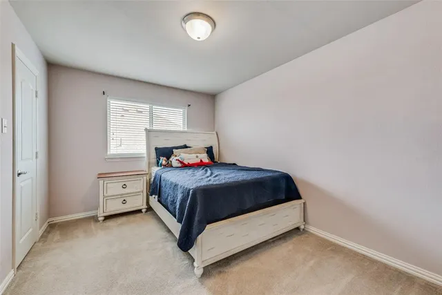 a bed room with a bed and window