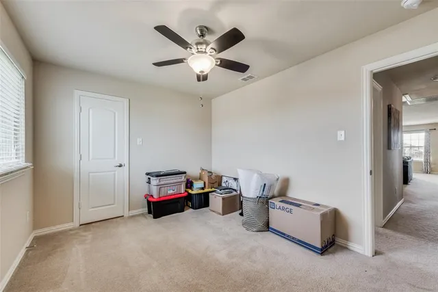 a living room with furniture and a ceiling fan