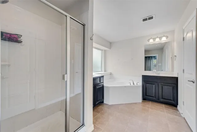 a spacious bathroom with a bathtub and a sink