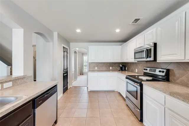 a view of a kitchen with electric appliances