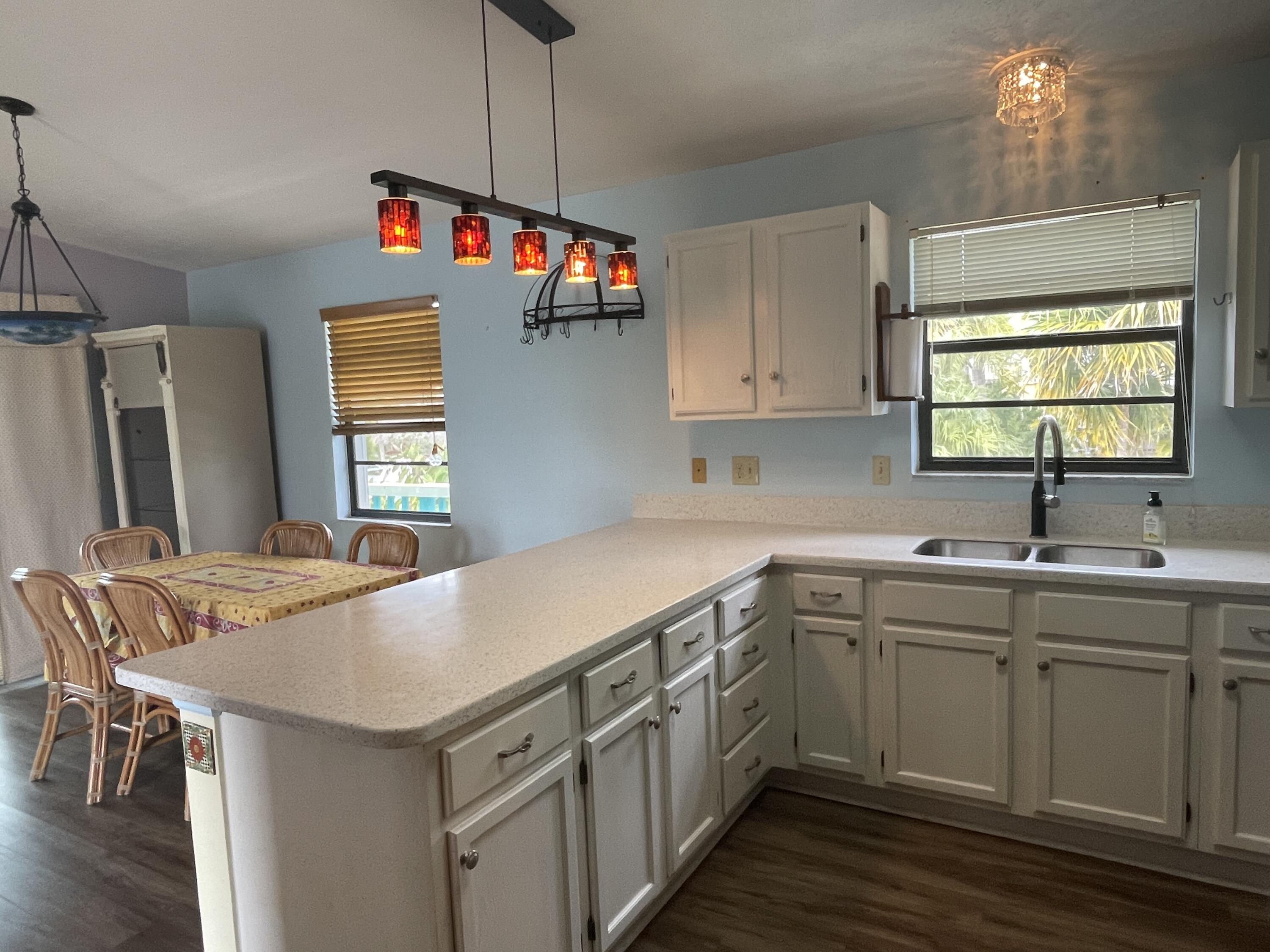 744 Blackbeard Road Summerland Key, FL 33042 - Photo 11 of 39 a kitchen with sink cabinets and wooden floor