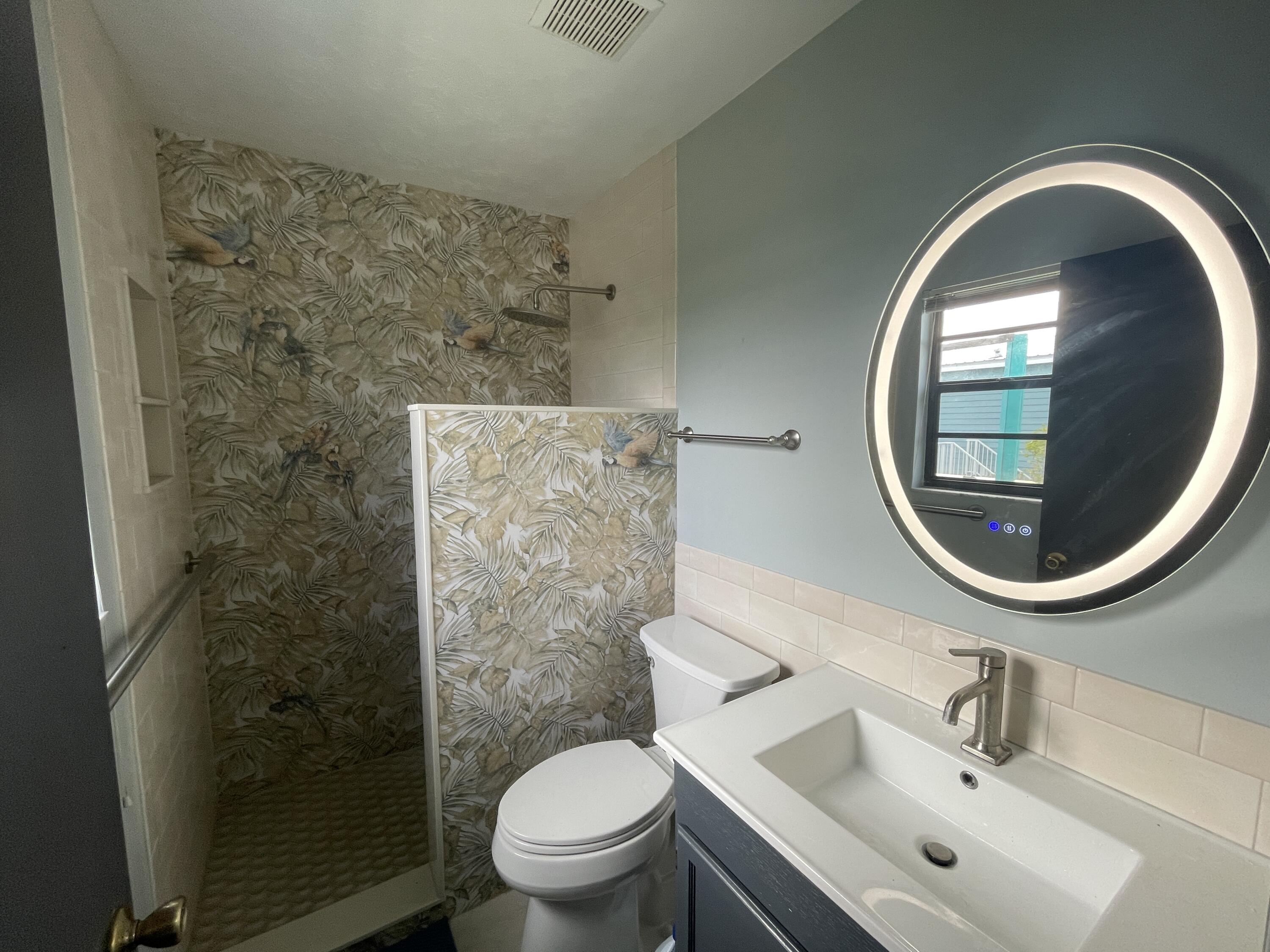 744 Blackbeard Road Summerland Key, FL 33042 - Photo 17 of 39 a bathroom with a sink mirror toilet and a shower