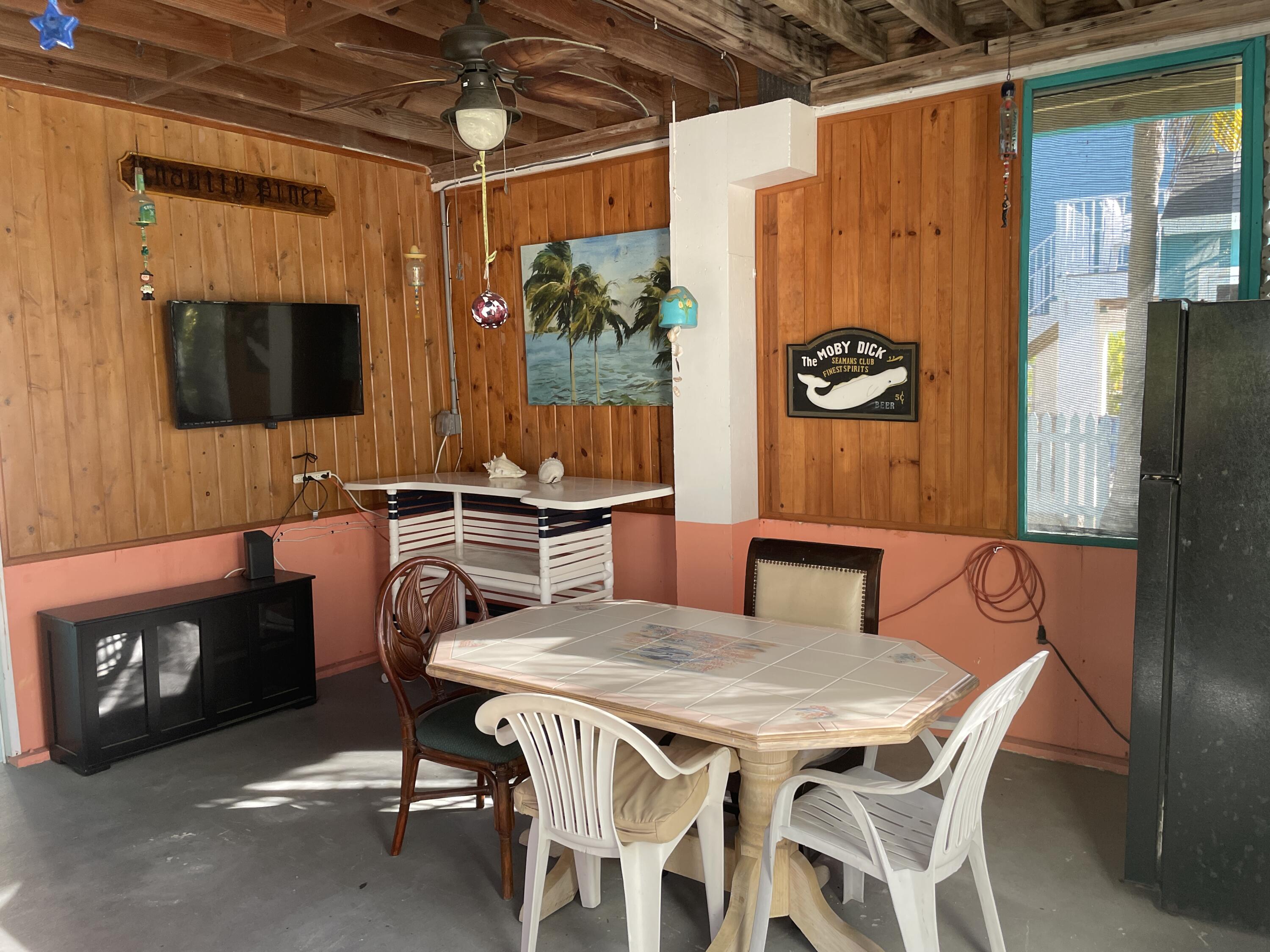 744 Blackbeard Road Summerland Key, FL 33042 - Photo 28 of 39 a view of a dining room with furniture and a window