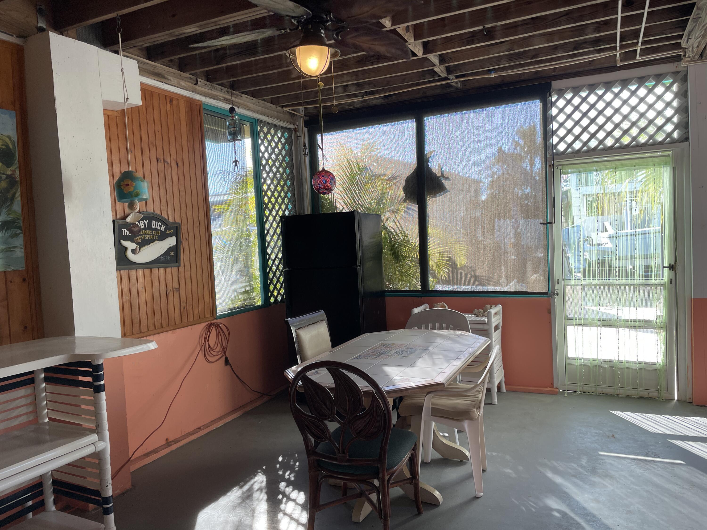 744 Blackbeard Road Summerland Key, FL 33042 - Photo 29 of 39 a view of a dining room with furniture window and outside view