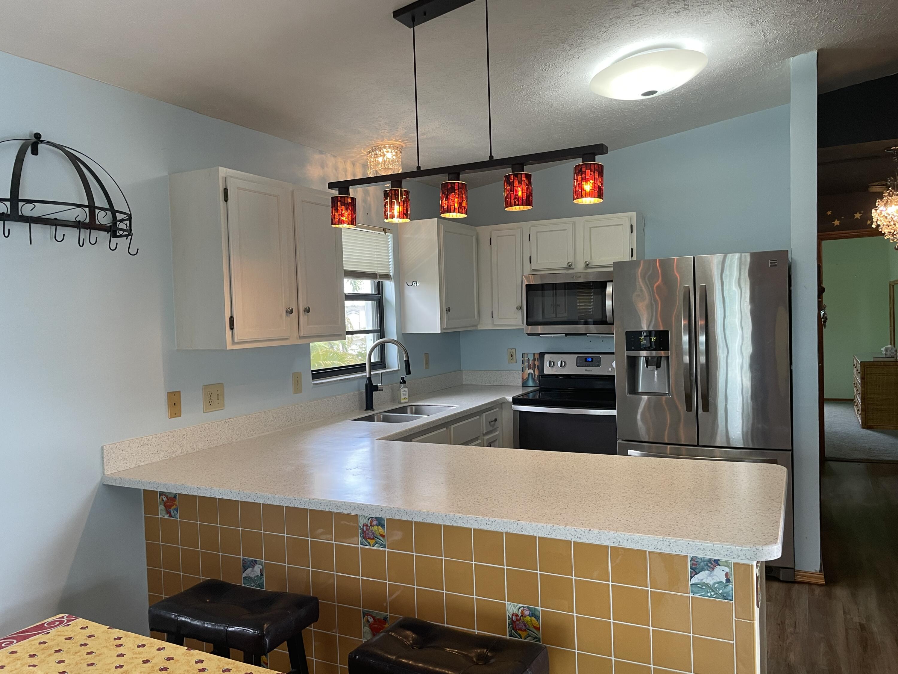 744 Blackbeard Road Summerland Key, FL 33042 - Photo 10 of 39 a kitchen with granite countertop a sink and stainless steel appliances