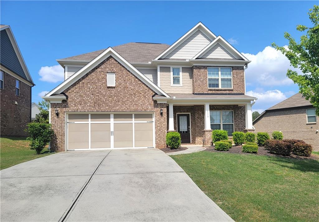 1775 Brookside Elm Drive Duluth, GA 30097 - Photo 1 of 1 a front view of a house with garden