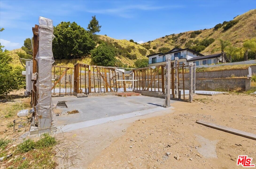 9865 Lanark Street Sun Valley, CA 91352 - Photo 1 of 13 a view of a road with wooden fence