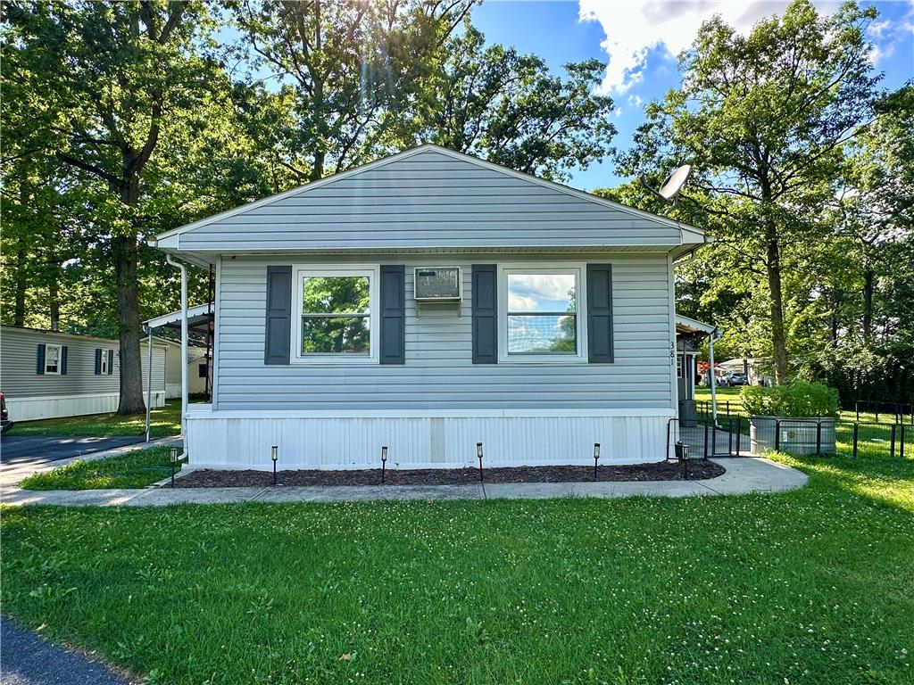 381 Red Oak Lane Bath, PA 18014 - Photo 27 of 27 A well-maintained single-story residence with a neatly trimmed lawn and mature trees.