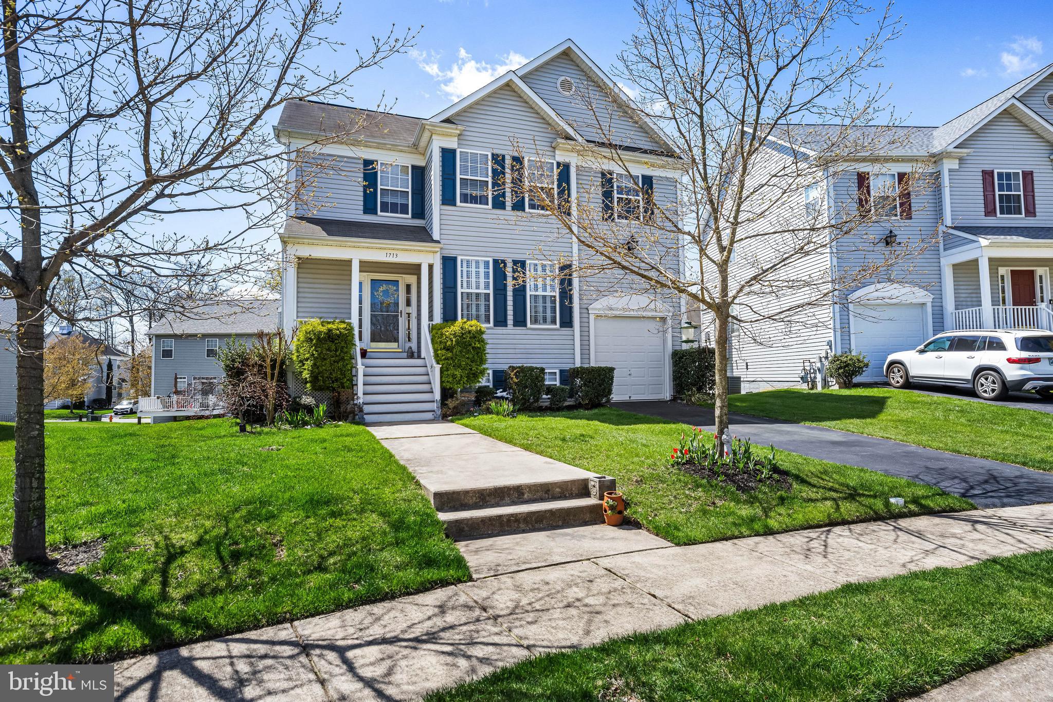 a front view of a house with a yard and garden