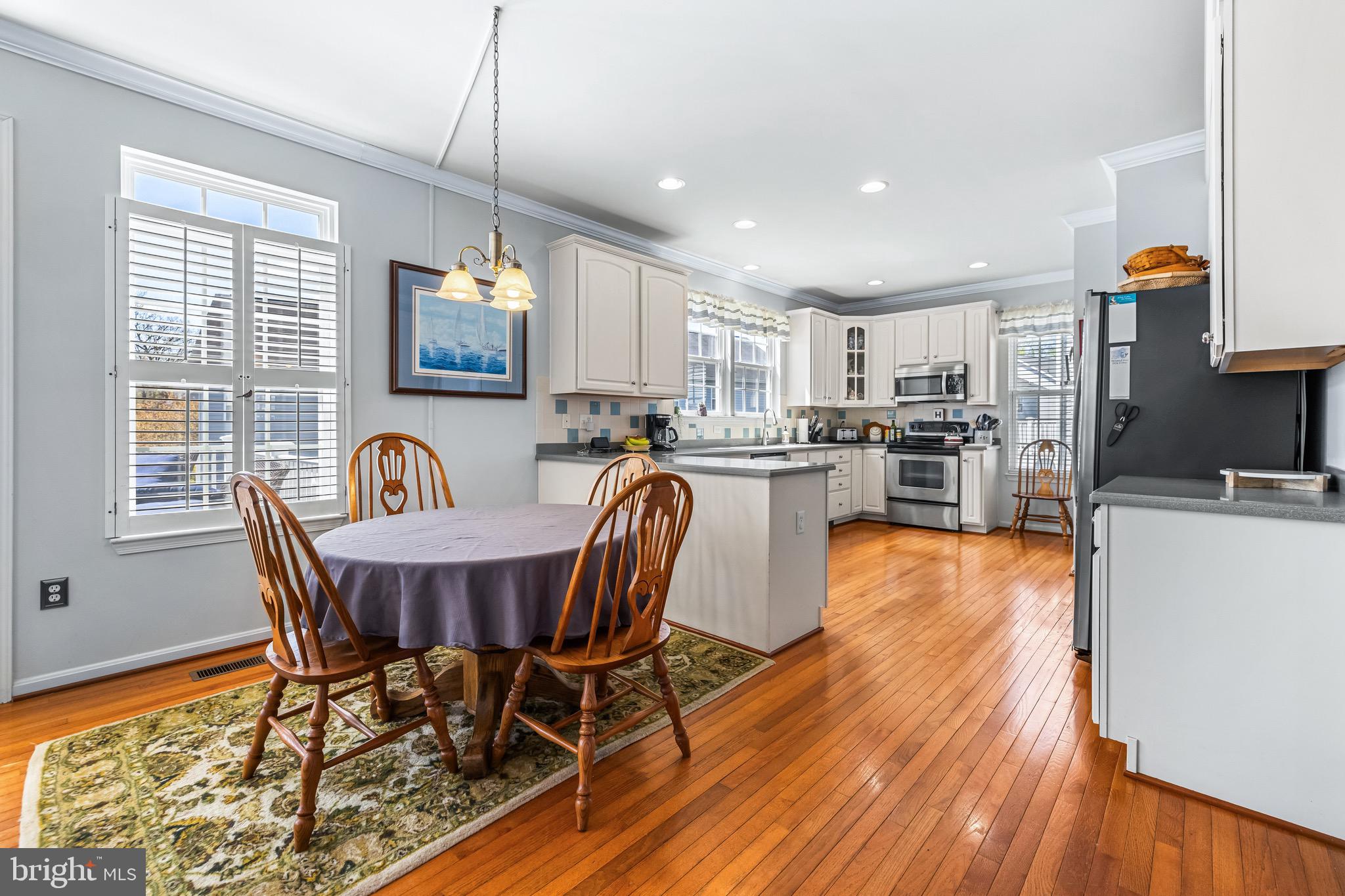 1713 Mystic Circle Baltimore, MD 21221 - Photo 12 of 37 a view of a dining room with furniture window and wooden floor