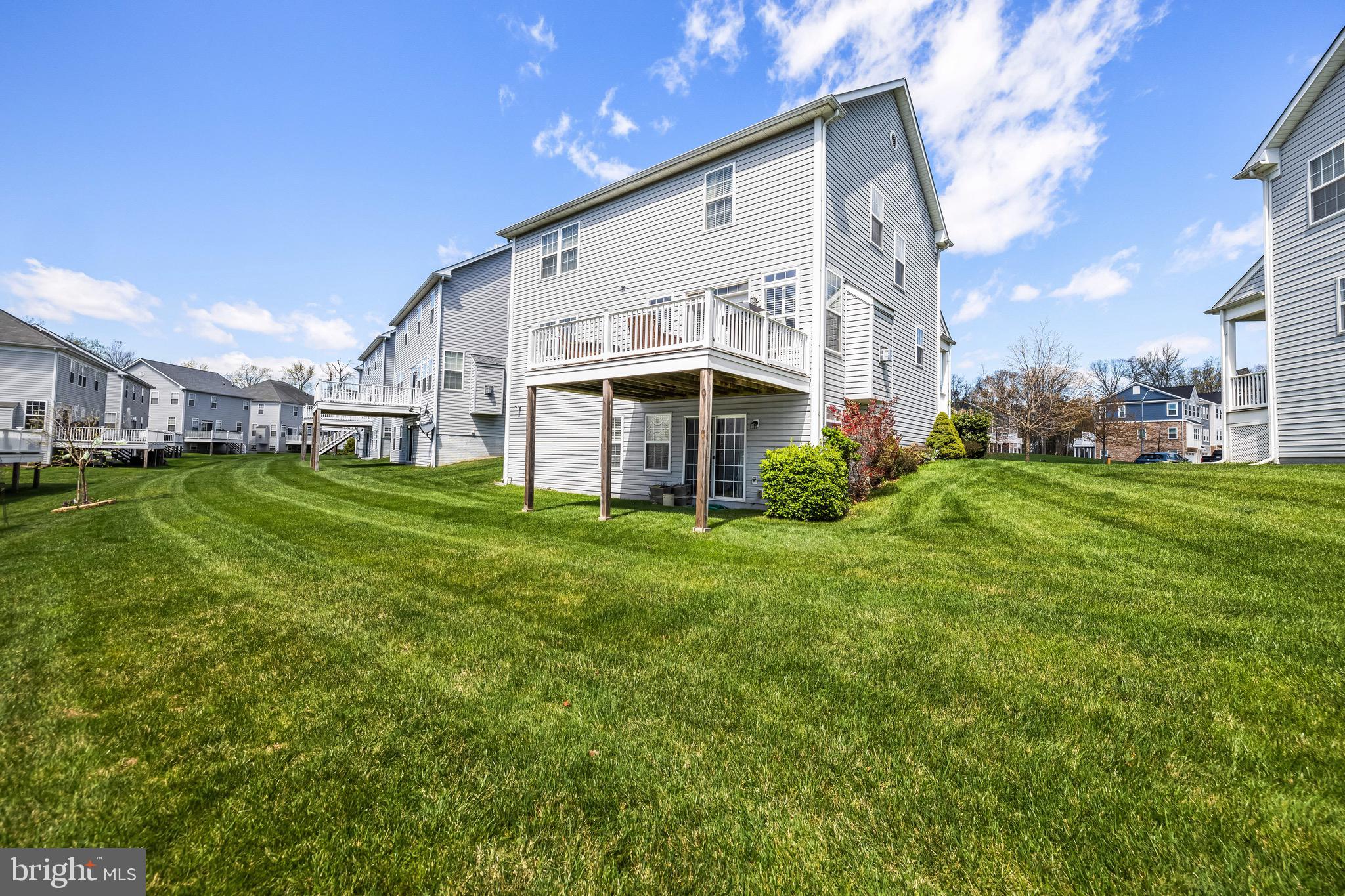 1713 Mystic Circle Baltimore, MD 21221 - Photo 33 of 37 a view of a white house with a big yard and large trees
