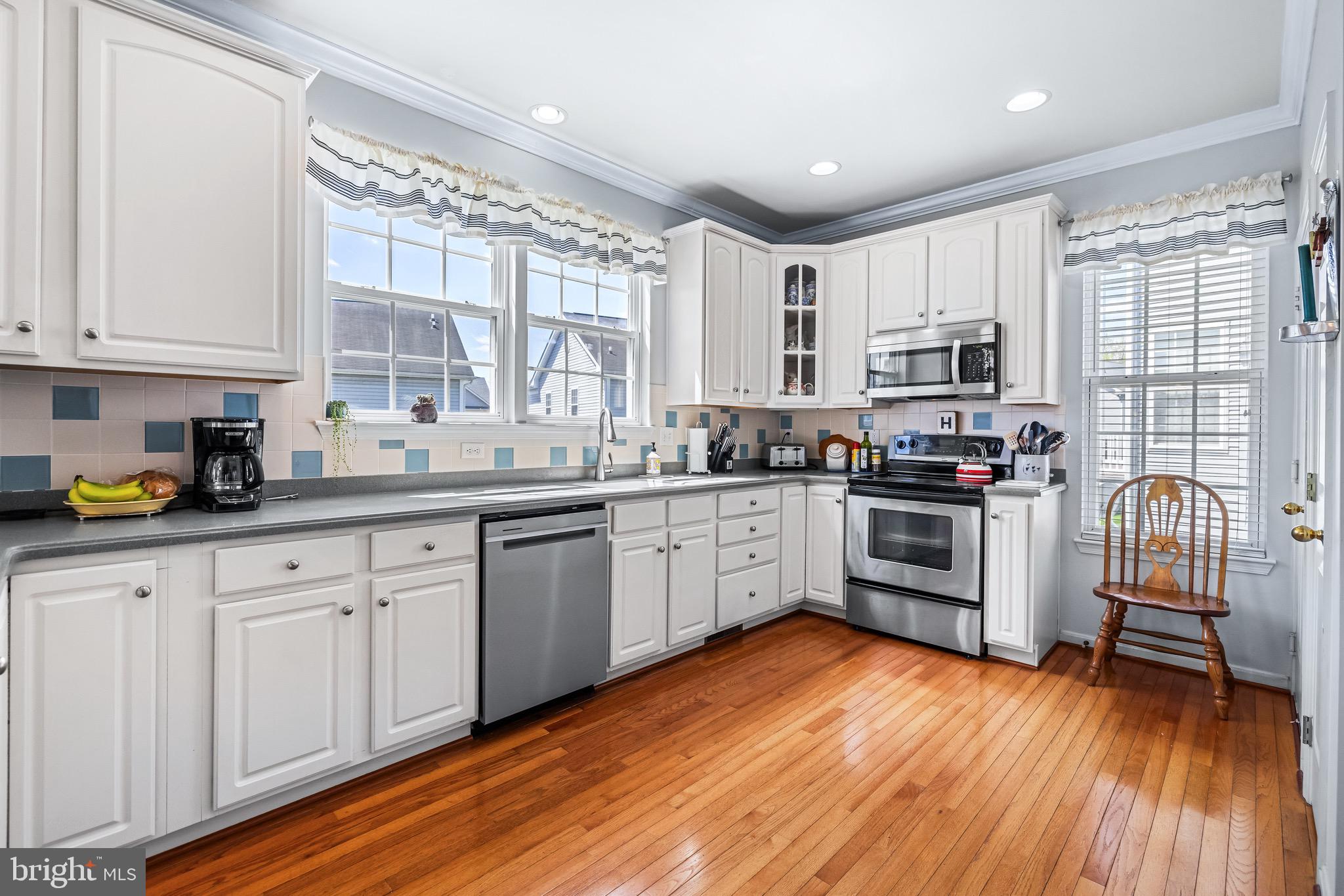 1713 Mystic Circle Baltimore, MD 21221 - Photo 8 of 37 a kitchen with stainless steel appliances granite countertop a stove top oven a sink dishwasher and a refrigerator with wooden floor