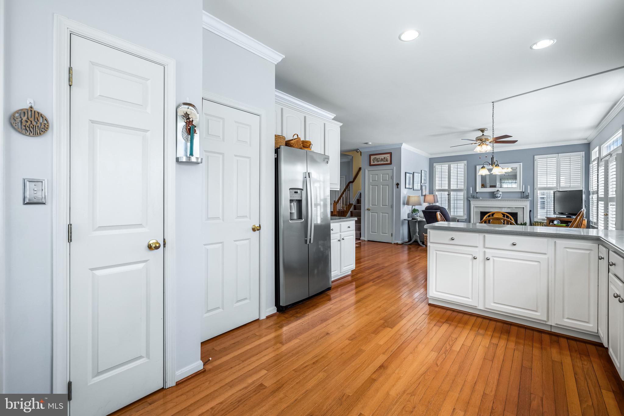 1713 Mystic Circle Baltimore, MD 21221 - Photo 9 of 37 a kitchen with stainless steel appliances a refrigerator and a wooden floor