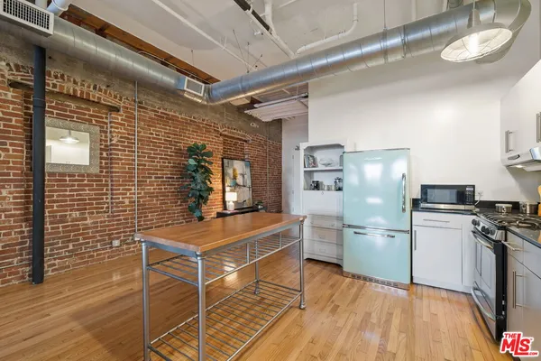a kitchen with refrigerator and microwave