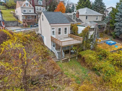 an aerial view of a house with a yard table and chairs