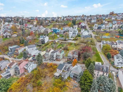 an aerial view of residential houses with outdoor space