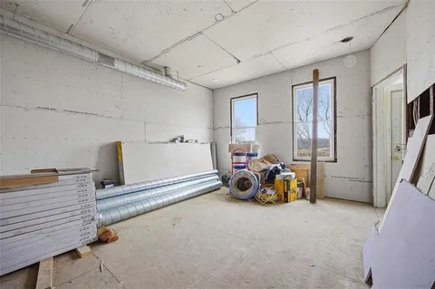 a view of a room with furniture and a window