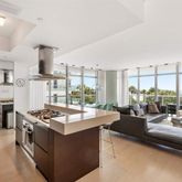 a living room with furniture and large windows
