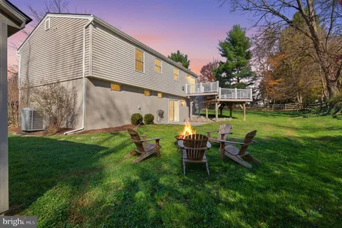 a backyard of a house with table and chairs