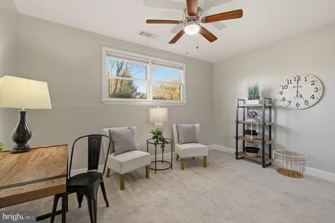 a living room with furniture a lamp and a window