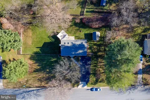 a view of a house with a yard and potted plants