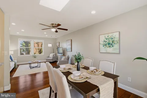 a view of a dining room with furniture a rug and wooden floor