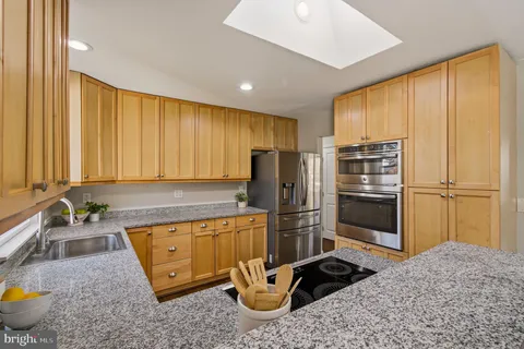 a kitchen with a refrigerator and a sink