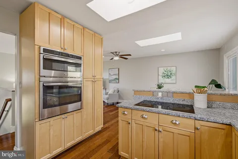 a kitchen with granite countertop stainless steel appliances and cabinets