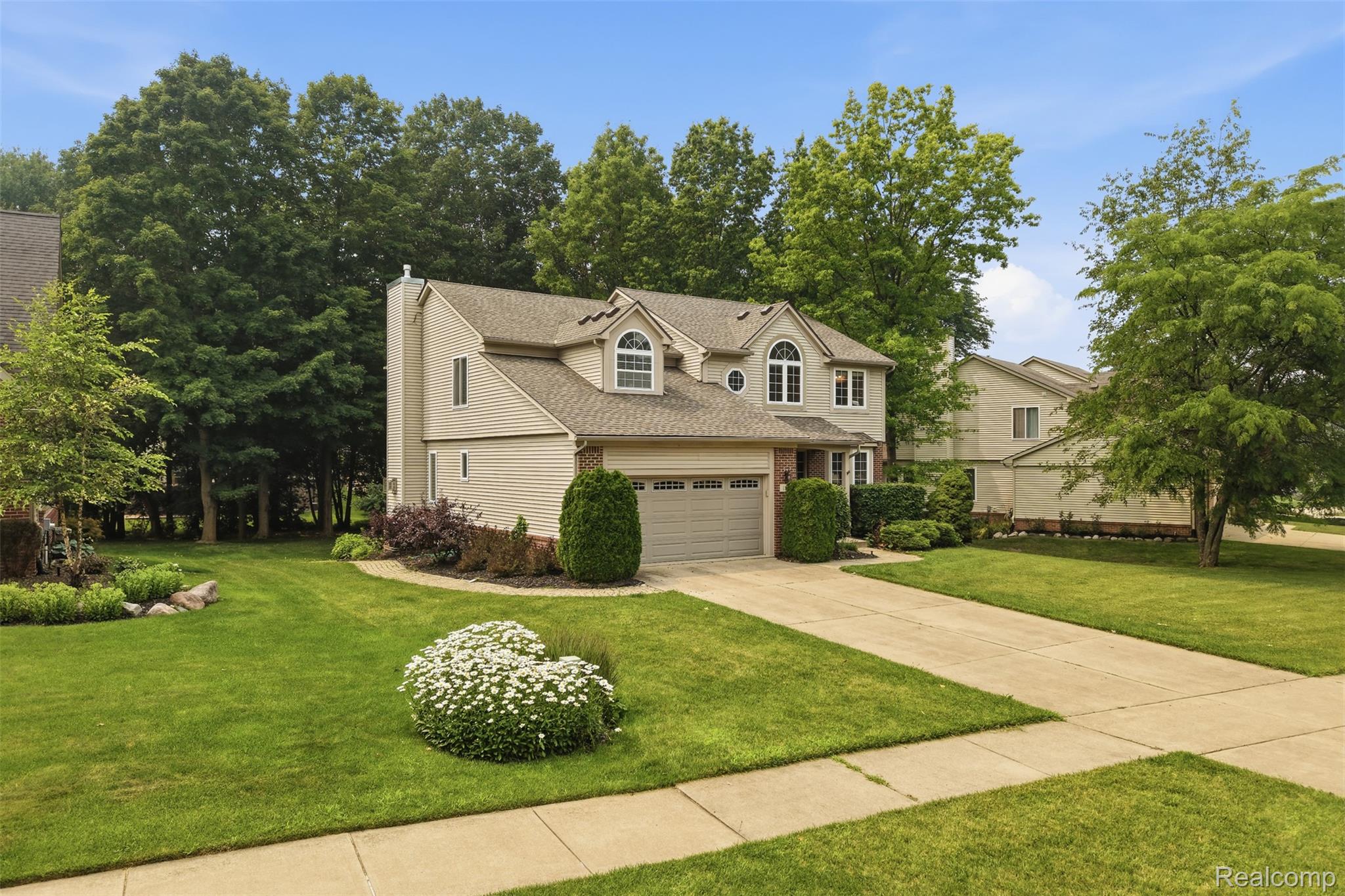 170 Fairhill Way Howell, MI 48843 - Photo 2 of 46 Two-story residence featuring light-colored siding, an attached two-car garage, and a gabled roofline