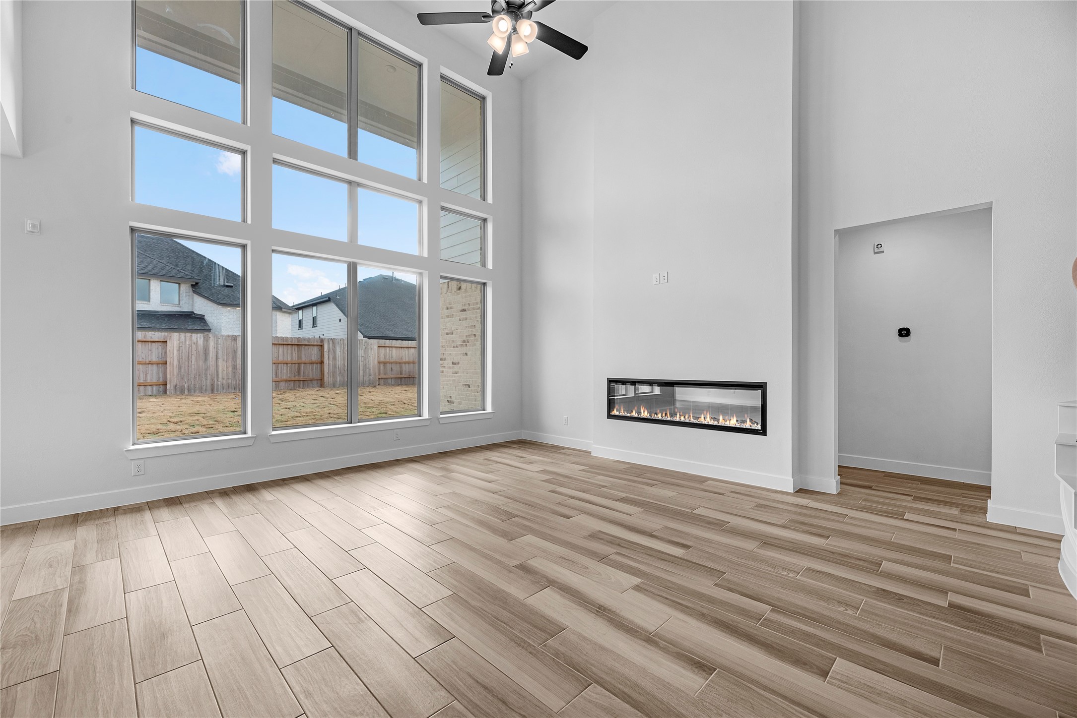 615 Roland Lane Rosenberg, TX 77471 - Photo 9 of 26 a view of an empty room with a window and wooden floor