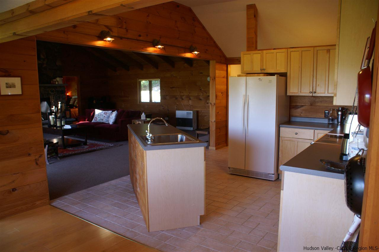 2727 Vega Mountain Road Roxbury, NY 12421 - Photo 30 of 31 a kitchen with refrigerator and couch
