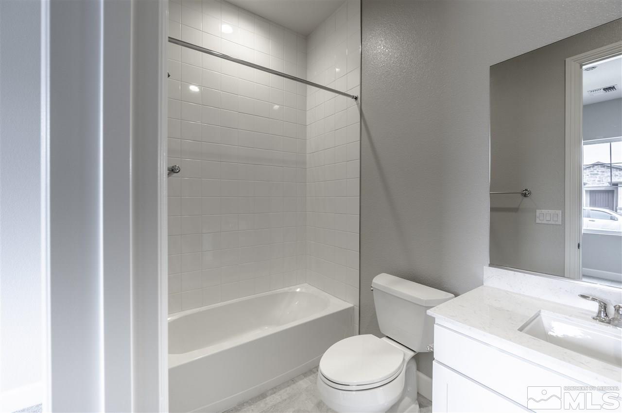 2516 Titanium Crest Drive, Unit HOMESITE 36 Reno, NV 89521 - Photo 13 of 19 a white toilet sitting next to a bath tub