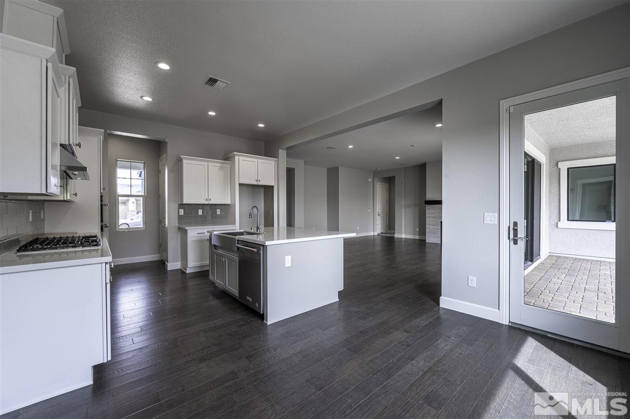 2516 Titanium Crest Drive, Unit HOMESITE 36 Reno, NV 89521 - Photo 7 of 19 a large kitchen with stainless steel appliances granite countertop a large counter top a stove a sink and a refrigerator