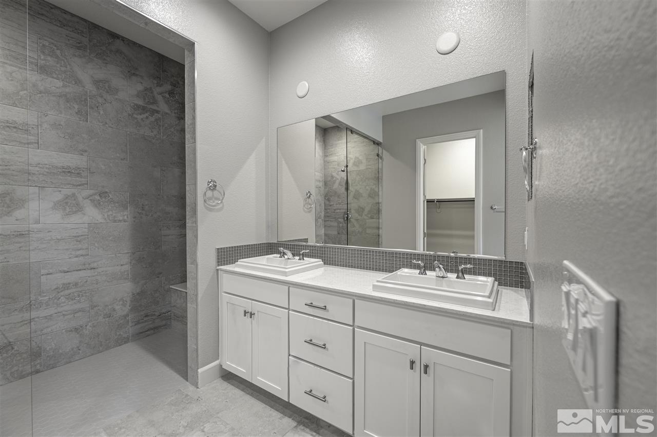 2516 Titanium Crest Drive, Unit HOMESITE 36 Reno, NV 89521 - Photo 10 of 19 a spacious bathroom with a double vanity sink a mirror and a shower