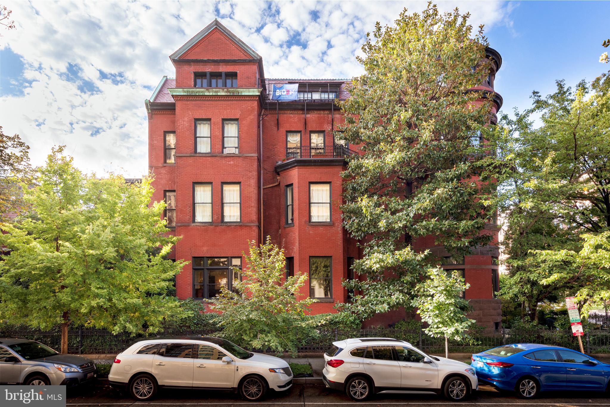 a view of cars parked in front of a building