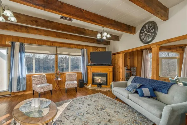 a view of front door with furniture and wooden floor
