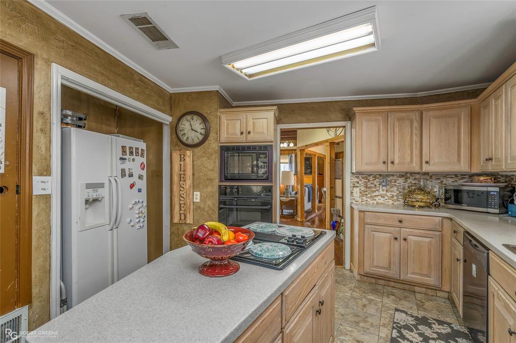 350 Brushy Creek Road Sibley, LA 71073 - Photo 28 of 40 a kitchen with stainless steel appliances granite countertop a sink a stove and a refrigerator