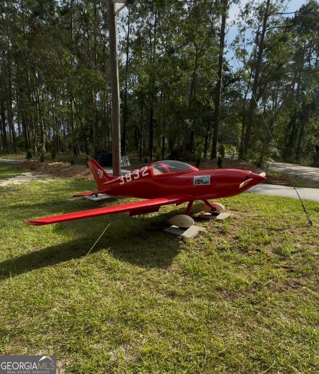 3932 Wilkerson Road Valdosta, GA 31606 - Photo 12 of 12 a view of swimming pool with lawn chairs and large trees