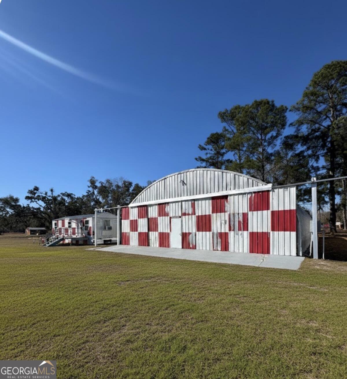 3932 Wilkerson Road Valdosta, GA 31606 - Photo 5 of 12 a view of swimming pool with a yard and seating area