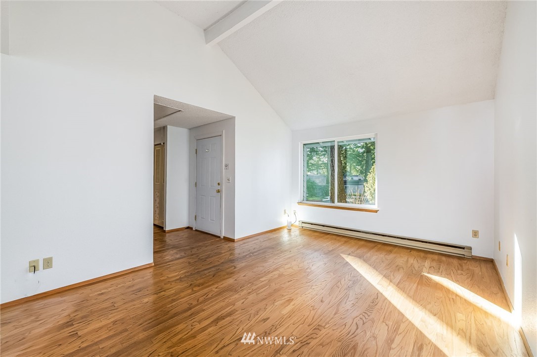 4308 Northeast Sunset Boulevard, Unit F3 Renton, WA 98059 - Photo 12 of 26 an empty room with wooden floor and windows