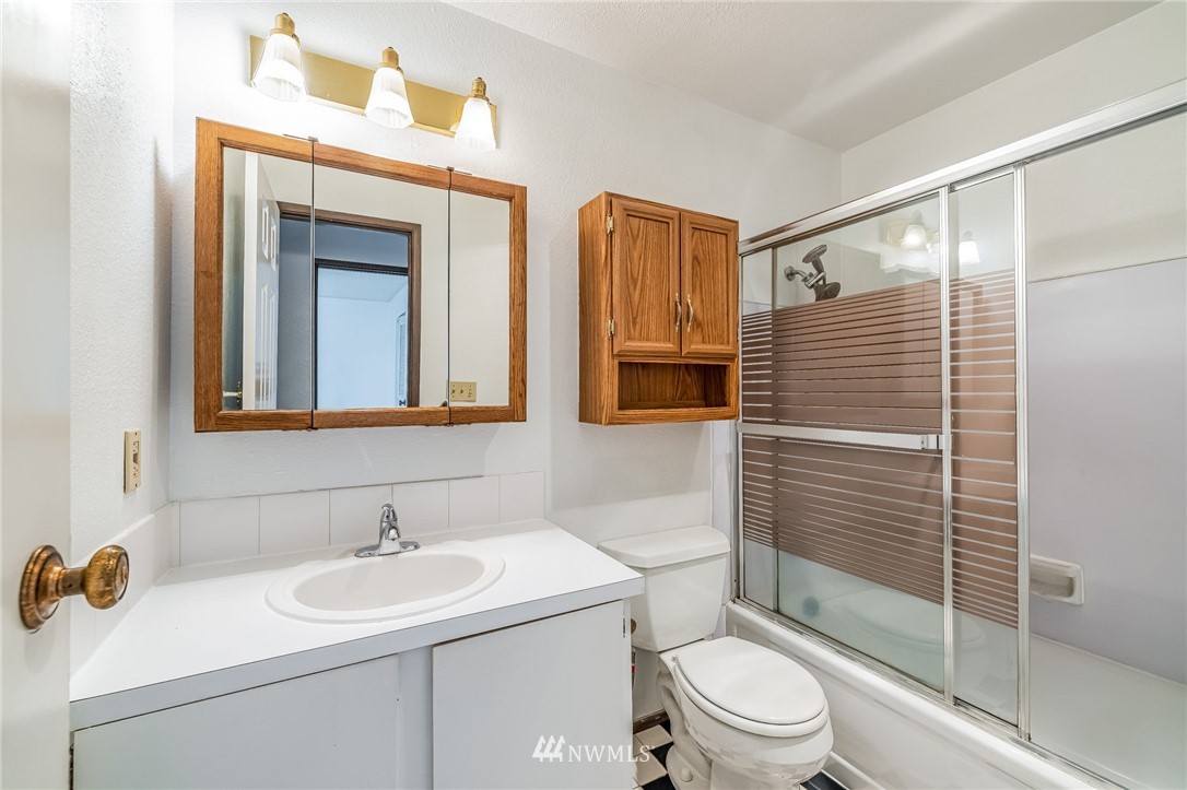 4308 Northeast Sunset Boulevard, Unit F3 Renton, WA 98059 - Photo 15 of 26 a bathroom with a sink a toilet and shower