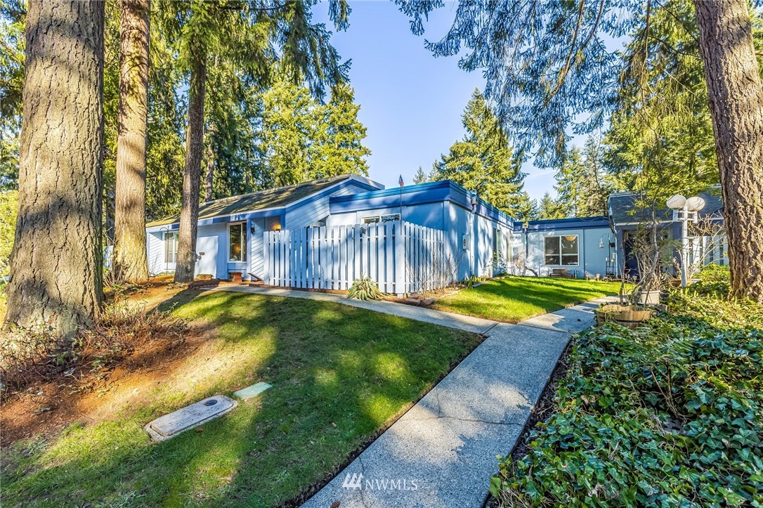 4308 Northeast Sunset Boulevard, Unit F3 Renton, WA 98059 - Photo 2 of 26 a view of a house with a small yard plants and large tree